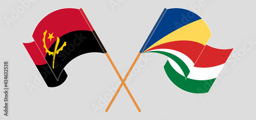Crossed and waving flags of Angola and Seychelles