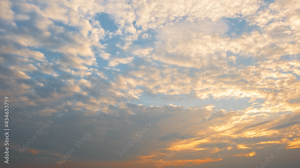 Colorful sunset and sunrise with clouds.Blue and orange color of nature.Many white clouds in the blue sky.The weather is clear today.sunset in the clouds.The sky is twilight.