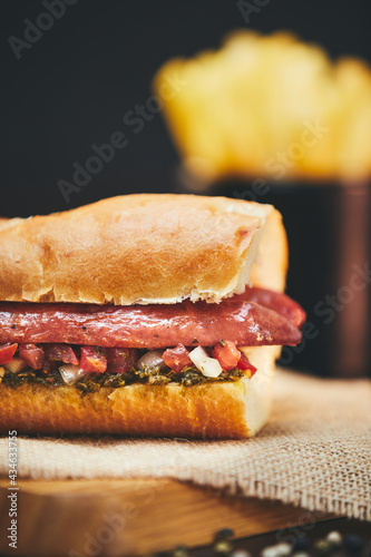 Argentinian choripan with chimichurri and creole sauce.