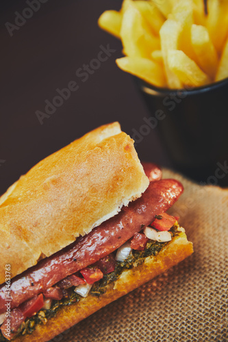 Argentinian choripan with chimichurri and creole sauce.