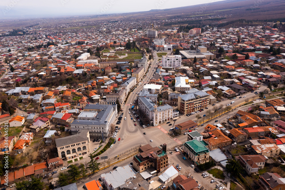 Panoramic aerial view of old Georgian town of Telavi overlooking modern buildings on central street in springtime, Kakheti