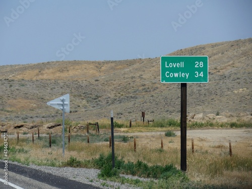 Roadside sign with distances to Lovell and Cowley, Wyoming. photo