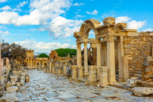 View of remained architectural elements of buildings and statues on main street of Curetes in Ephesus in winter day, Izmir province, Turkey photo