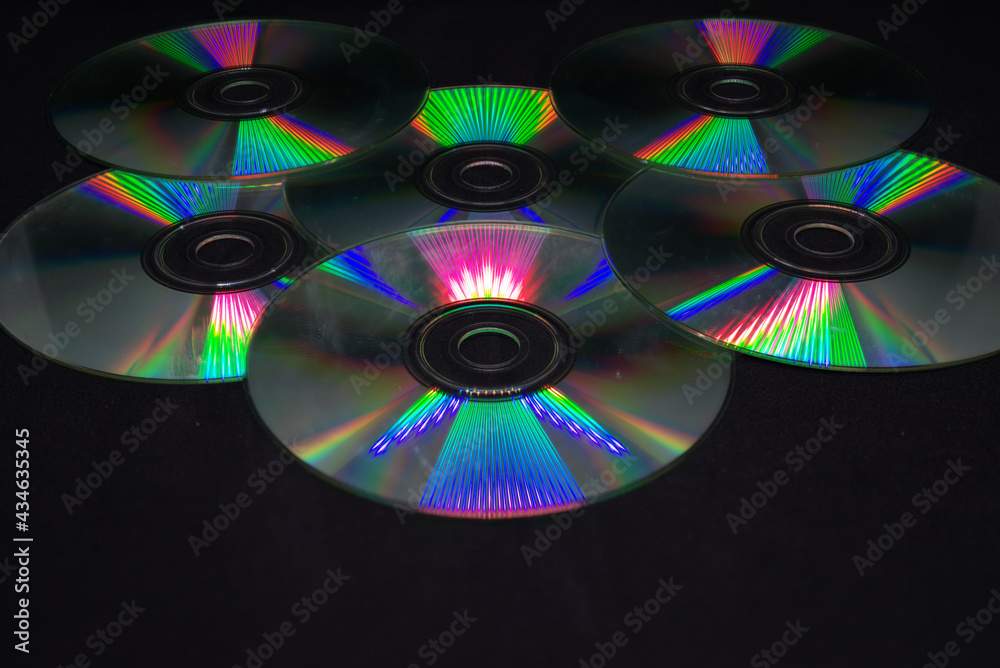 A pile of cd rom on black