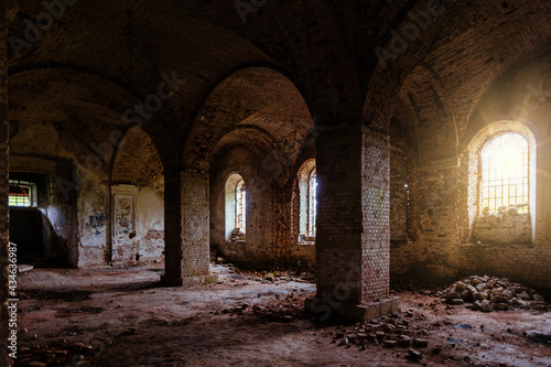 Large ancient vaulted hall of abandoned building.