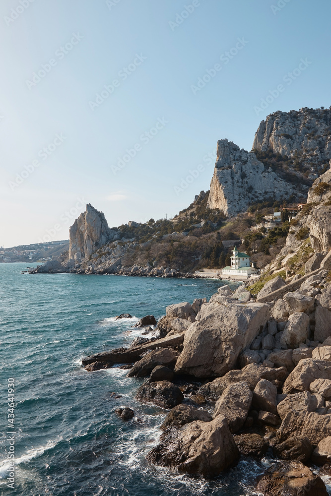 wallpaper, house, building on the shore of a rocky beach, sea and mountains, waves crashing on the rocks