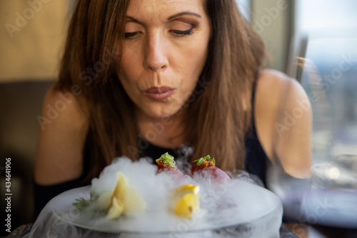 Fresh Bluefin Tuna Sushi Nigiri plate covered with dry ice smoke