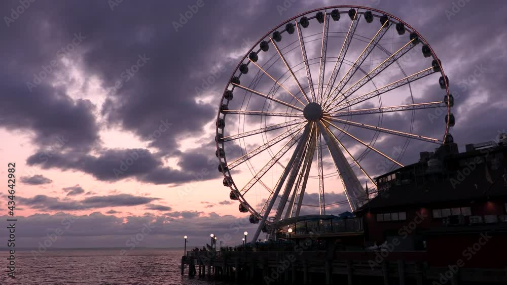 Timelapse or time lapse of The Great Wheel and boats at sunset, Pier 57, Seattle, Washington, USA Timelapse or time lapse of The Great Wheel and boats at sunset, Pier 57, Seattle, Washington, USA