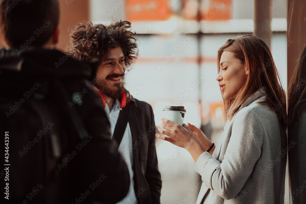 two young people are drinking coffee and taking a break from work