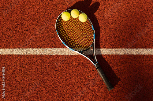 Tennis Ball with Racket on the racket in tennis court photo