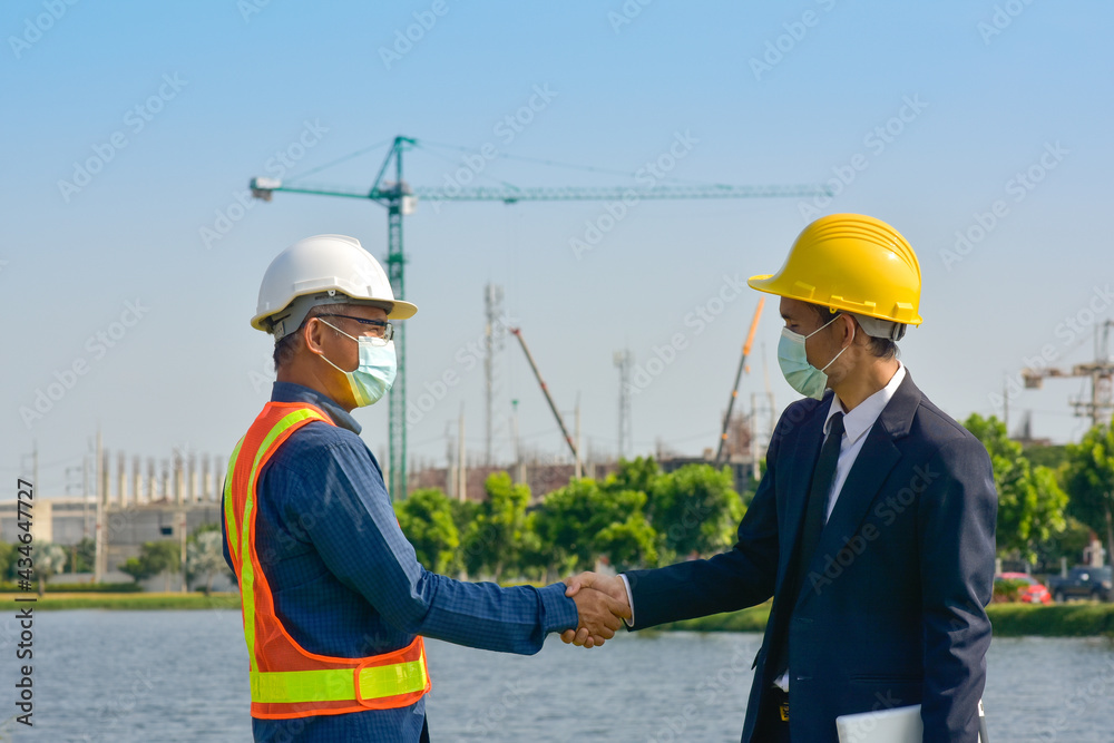 Two people Engineer teamwork outdoor working on site construction Two people Engineer teamwork outdoor working on site construction