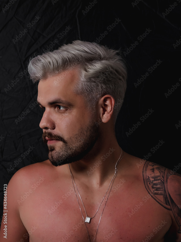 Fototapeta premium Caucasian Man Platinum Blonde White Hairstyle With Short Haircut and Moustache No Shirt and Sun Tan Gray Hair And Shoulder Tattoo
