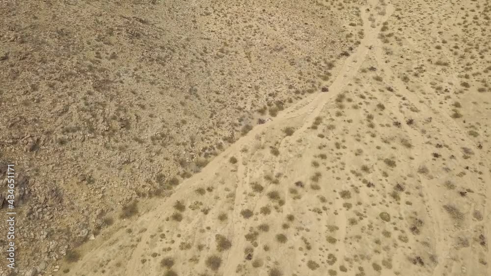 Aerial birds eye shot of abandoned desert with dried plants during hot summer day in Joshua Tree National Park,California. Aerial birds eye shot of abandoned desert with dried plants during hot summer day in Joshua Tree National Park,California.