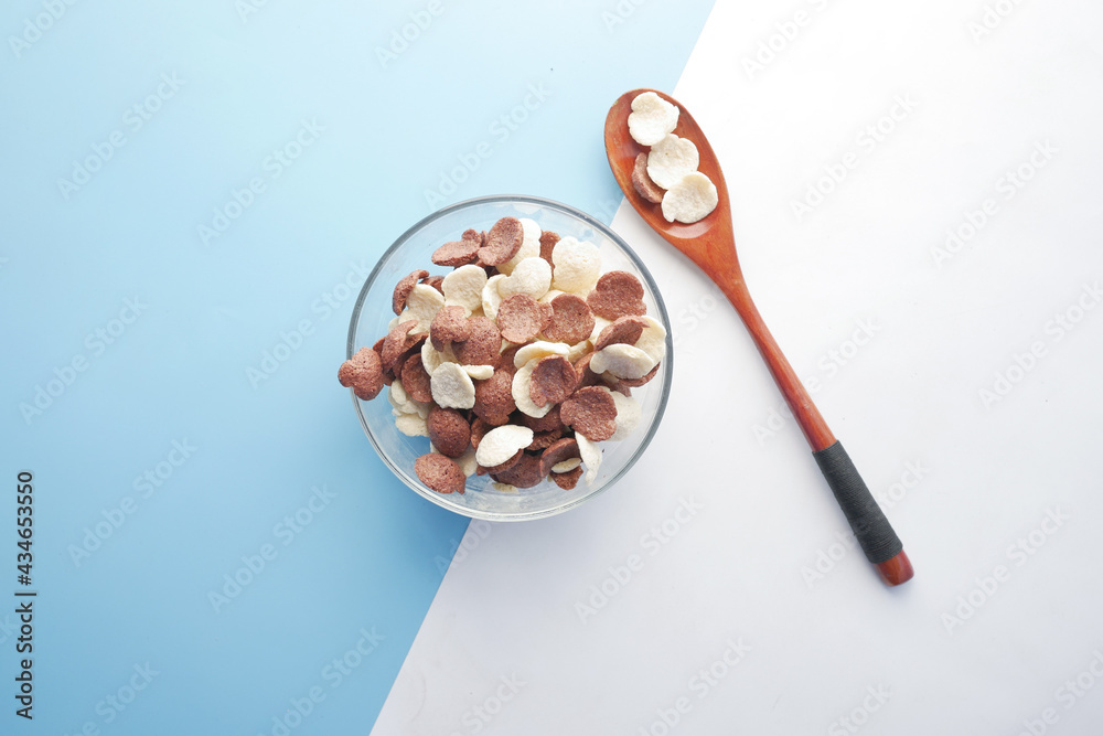 Top view of chocolate corn flakes in a bowl on pink Top view of chocolate corn flakes in a bowl on pink