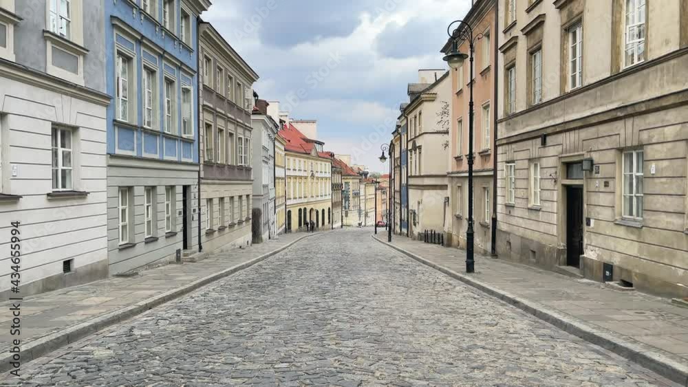 Walking through a paved street in Warsaw Old Town area. Walking through a paved street in Warsaw Old Town area.