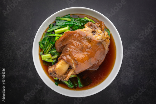 Kha Moo Pa Lo, Thai food, brown Chinese stewed pork leg in sweet brown sauce on dark tone texture background, top view shot