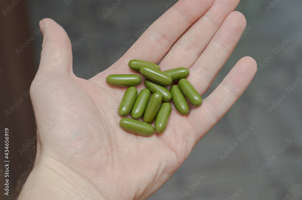 sport and diet concept - male hand with vitamins sport and diet concept - male hand with vitamins