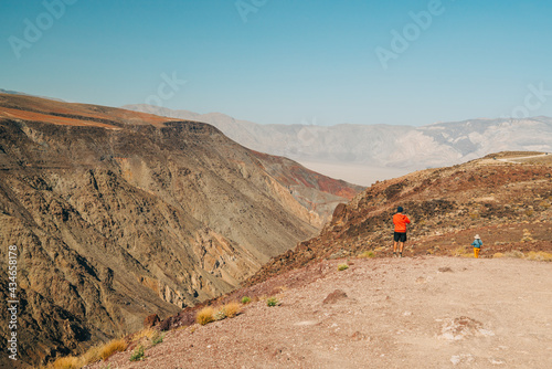 Panamint Valley from Padre Crowley Point at 4000 feet in Death Valley National Park, and silhouette of walking tourists photo