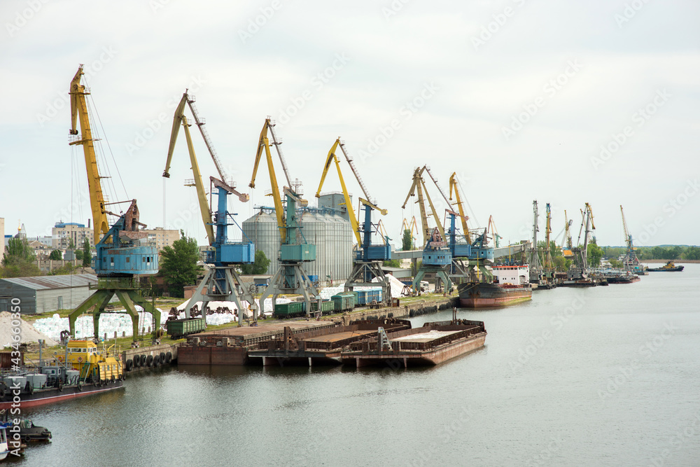 river port with cranes, moored ships, barges, railway wagons