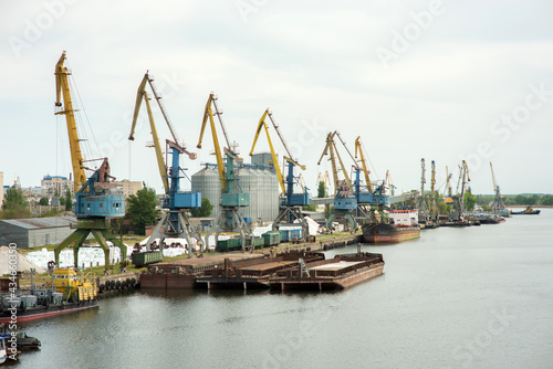 river port with cranes, moored ships, barges, railway wagons