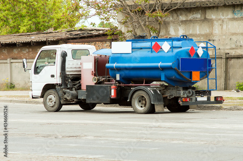 A fuel truck with a blue cistern is driving along the City Highway.