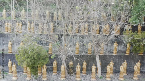 Sliding view of Spectacular Golden Buddhism Sculptures at Hushan Temple in Douliu City Taiwan.  photo