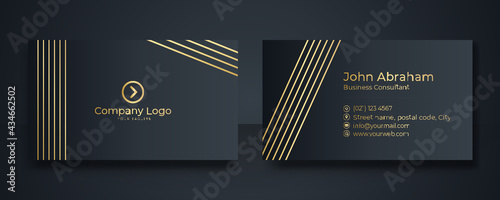 Modern Business Card - Creative and Clean Business Card Template. Luxury business card design template. Elegant dark back background with abstract golden wavy lines shiny. Vector illustration