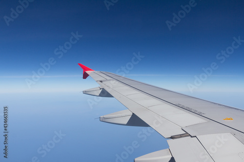 wing of airplane with blue sky