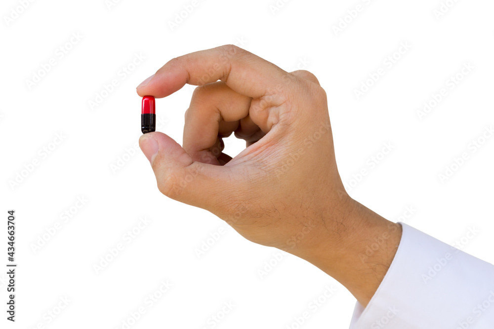 Fototapeta premium A man hold a pill or capsule between thumb and forefinger on white background