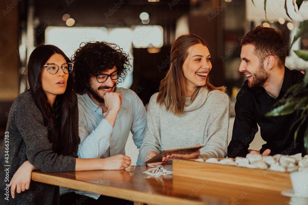 A group of friends hanging out in a cafe, and talking about business A group of friends hanging out in a cafe, and talking about business