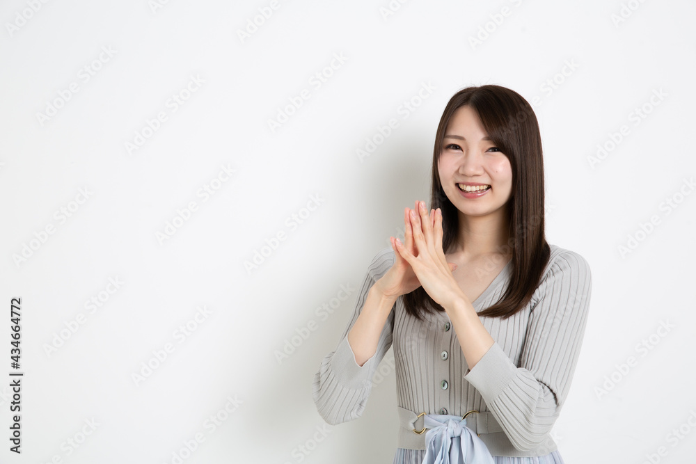 両手を合わせて喜んでいる日本人女性 Stock Photo Adobe Stock