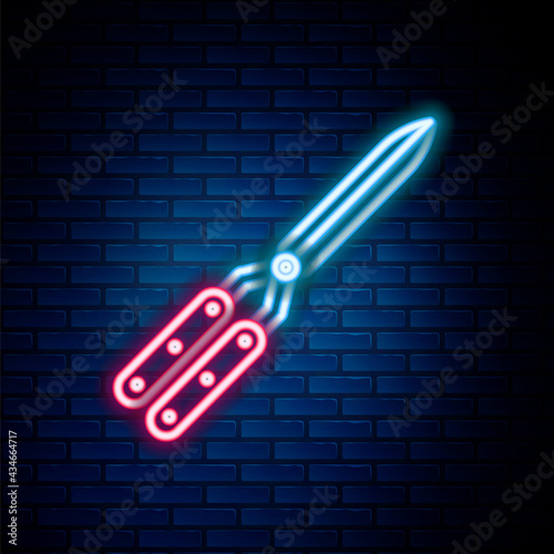 Glowing neon line Gardening handmade scissors for trimming icon isolated on brick wall background. Pruning shears with wooden handles. Colorful outline concept. Vector