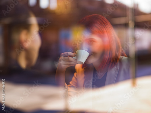 two women sit in a cafe and talk