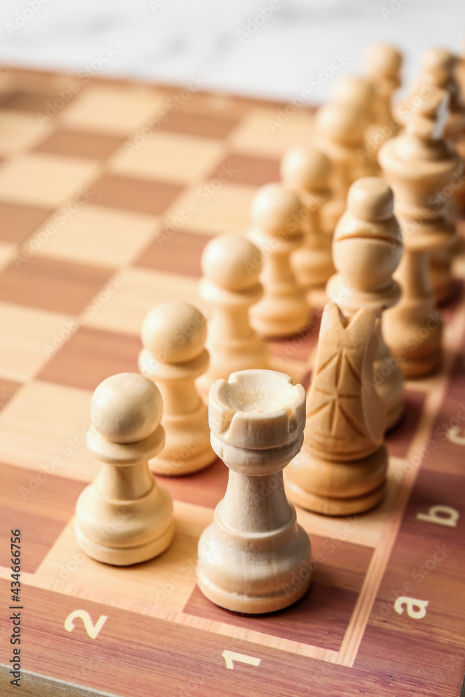 Chess pieces with game board on light background Chess pieces with game board on light background