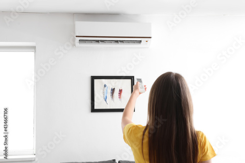 Young woman with air condit...