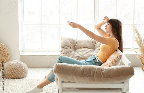 Young woman with air condit...