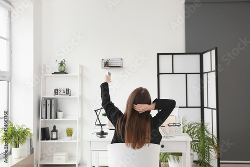 Young woman with air condit...