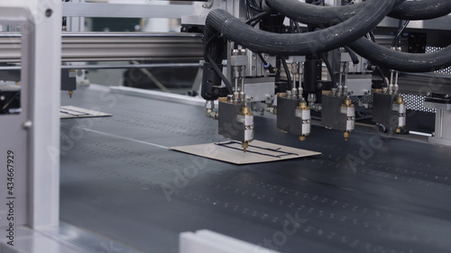 Modern automatic machine line of cardboard box. Conveyor line for the production Manufacture of cardboard boxes from paper. gluing of cardboard.