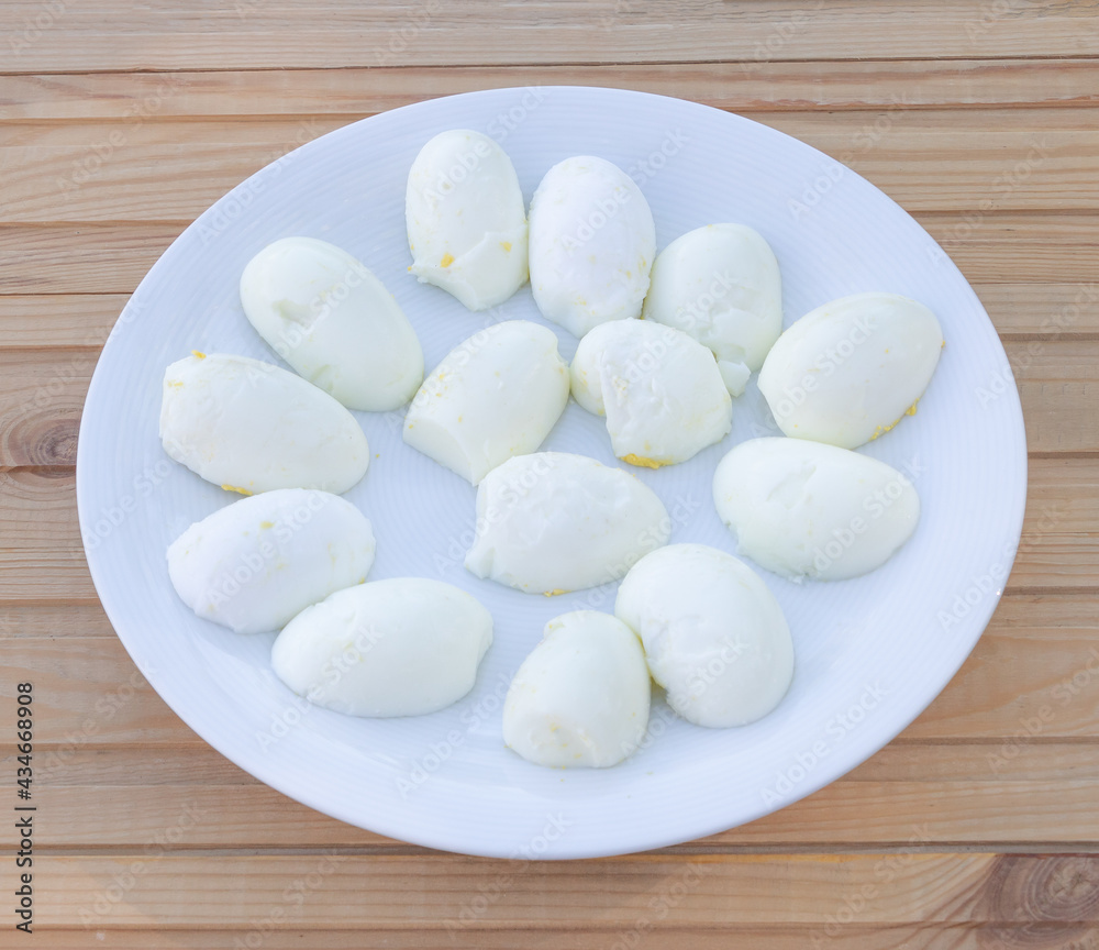 Boiled eggs and cut in half in a plate - Wooden background
