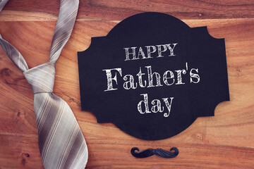 top view image of fathers day composition with vintage father's accessories and blackboard