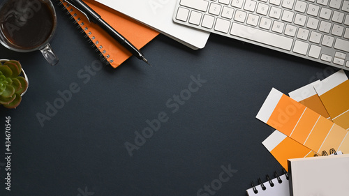 Konstfotografi Top view designer workspace with color swatch, notebook, houseplant and coffee cup on black leather