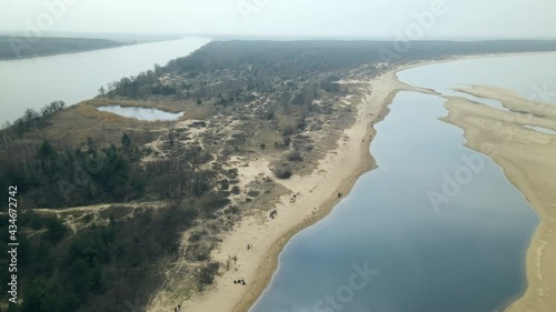 Panoramic View Of Mewia Lacha With People On Dune Seashore In Sobieszewo Island, Bay Of Gdansk, Baltic Sea, Poland. - Aerial Pullback Shot photo