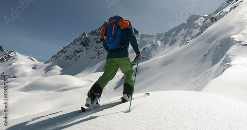 Ski touring with a professional ski mountain guide. Perfect snow conditions and beautiful mountain landscape the perfect place for ski touring in tirol. Cold winter skitour, skiguide 4K flollow camera photo