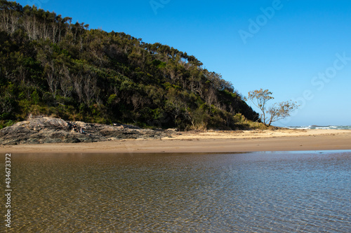 Ocean inlet with moutians and trees in Australia photo