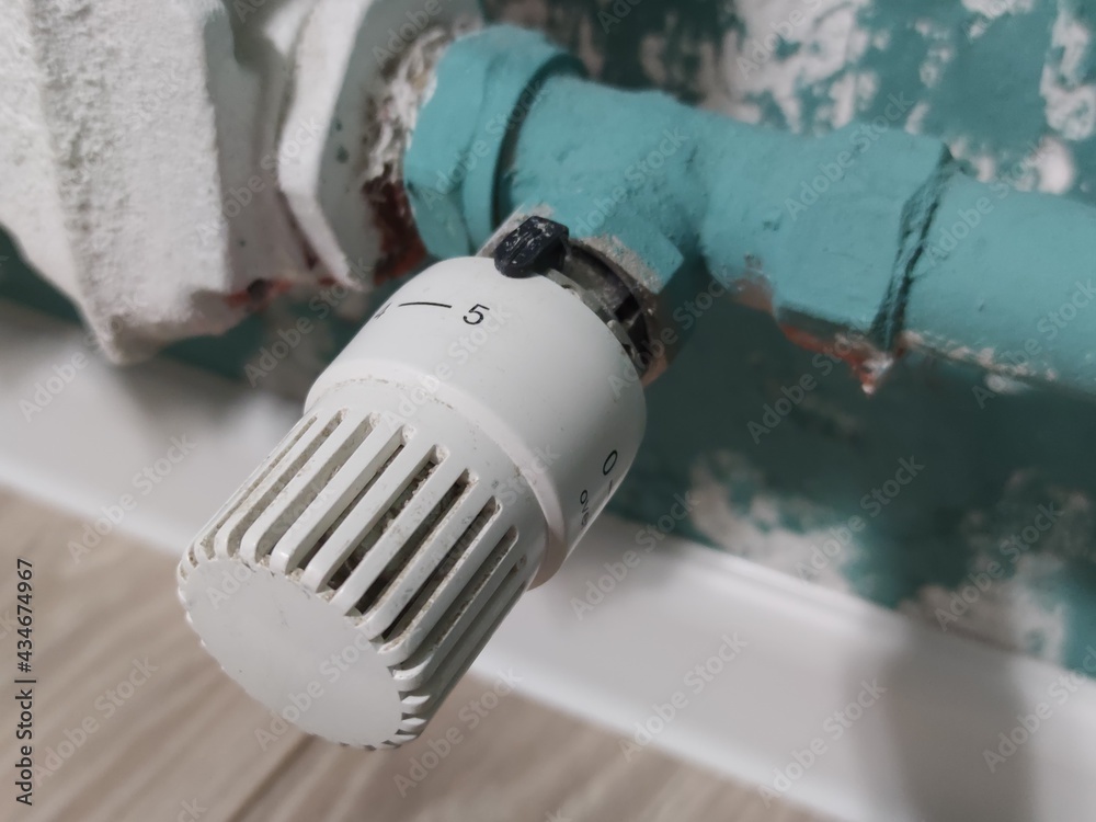 Saving heat. Heating system in apartments. Adjust the battery temperature. Thermal energy, close-up. Saving heat. Heating system in apartments. Adjust the battery temperature. Thermal energy, close-up.