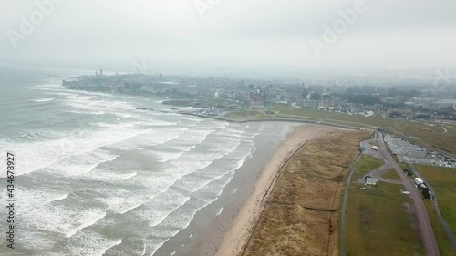 St Andrews city shrouded in fog and rough sea, Scotland. Aerial forward photo