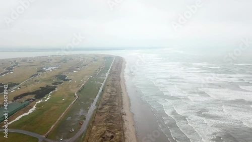 Aerial view of Royal and Ancient Golf Club of St Andrews and rough sea, Scotland photo