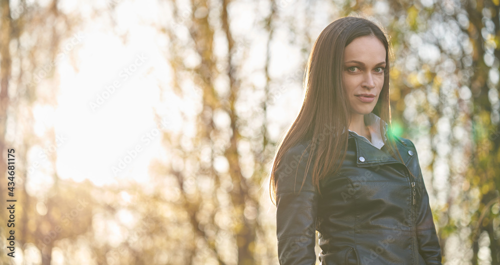Pretty brunette woman is walking in the park Pretty brunette woman is walking in the park