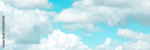 Blue sky with white clouds panoramic banner © Ilya