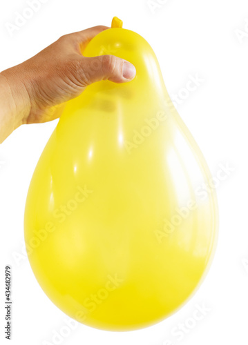 Inflated yellow balloon in hand isolated on white